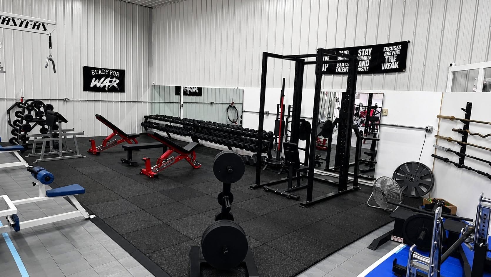 Power rack, dumbbell rack and adjustable benches on the Blue Water Fitness free weight floor